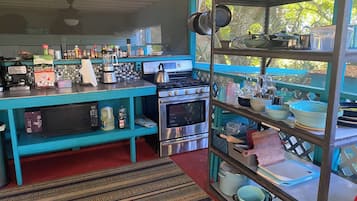 Fridge, microwave, coffee/tea maker, cookware/dishes/utensils