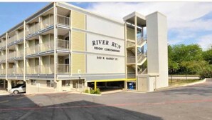 A multi-story building with balconies, labeled "River Run Resort Condominiums, 500 N. Market St." - Updated Comal River Condo, 2 bedroom,2 bath, 1 mi to Schlitterbahn (New Braunfels)