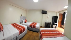 A hotel room with three beds, a TV, a desk, and a wardrobe. - Hotel Horizonte (Machu Picchu)