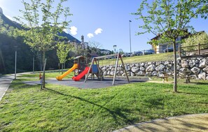 Explore a serene park with a playground, picnic area, and scenic views of the surrounding mountains.