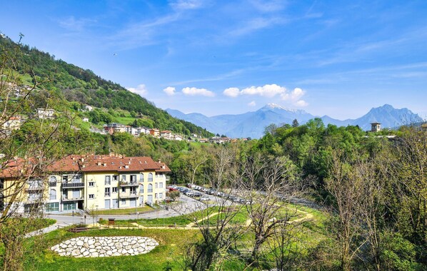 Experience the tranquility of this mountain village, where a charming hotel offers comfortable accommodations with balconies and a beautiful garden.