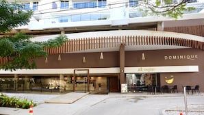 A modern building with a 'DOMINIQUE' sign, a restaurant named 'altoque', and a clear entrance with a glass door. - 5 minutes walk to the beach - Unit with Jacuzzi on private balcony (La Boquilla)