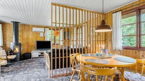 A cozy cabin interior with a wooden interior, a fireplace, a TV, and a dining area. - 2 bedroom beautiful home in Toftlund (Toftlund)
