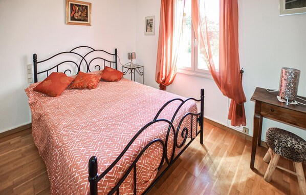 A neatly arranged bedroom with a bed, a small desk, and a chair. - Amazing home in La Bastide-des-Jourdan (La Bastide-des-Jourdan)