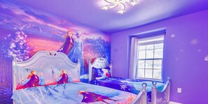 A bedroom with a bed featuring a Frozen-themed mural, a window with a view, and purple walls. - *2024* Magical 5BD/4.5BH w/GameRoom - 8mi/Disney (Davenport)