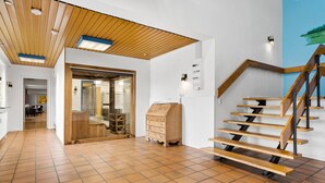 A spacious hallway with a wooden staircase and a glass door leading to another room. - 11 bedroom gorgeous home in Hurup Thy (Hurup Thy)