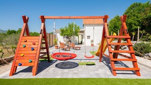 A playground with a swing set, slides, and climbing structures. - Beautiful home in Zavojane (Zavojane)