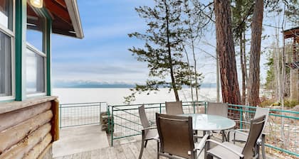 Lakefront home with amazing mountain views, wraparound deck, fireplace, & grill
