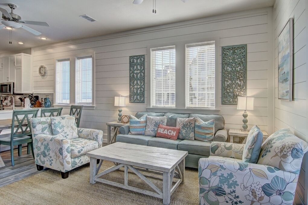 A living room with a sofa, chairs, a coffee table, and decorative pillows.