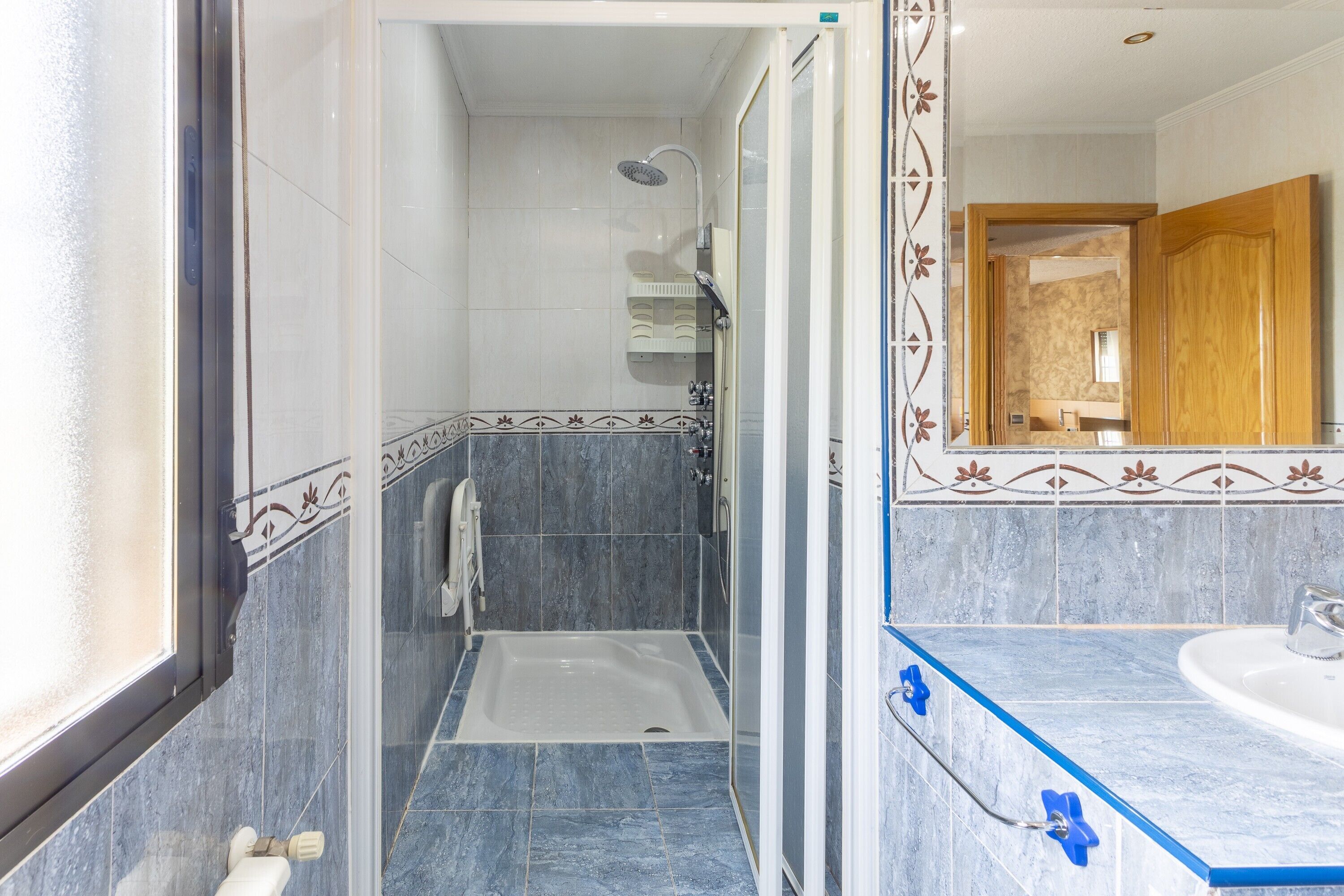 A bathroom with a shower, a bathtub, and a sink.