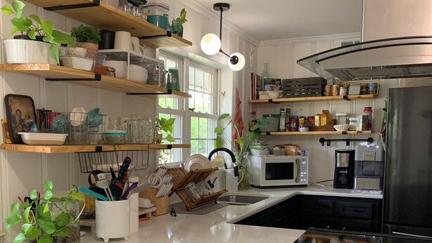 A modern kitchen with white countertops, stainless steel appliances, and wooden shelves. - Please do not book (Augusta)