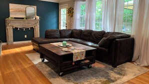 A living room with a sectional sofa, a coffee table, and a fireplace. - Please do not book (Augusta)