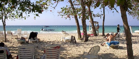 On the beach, sun-loungers