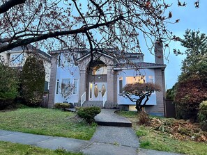 A two-story house with a brick facade, a front porch, and a small front yard. -  * IDEAL COZY PRIVATE SUITE W 2 BEDROOMS  - NEAR YVR DOWNTOWN  (Vancouver)