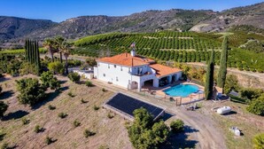 A white villa with a red-tiled roof, a swimming pool, and solar panels. - Mediterranean House in De Luz (Temecula)
