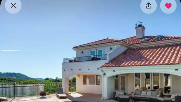 A two-story house with a swimming pool and outdoor seating area. - Mediterranean House in De Luz (Temecula)
