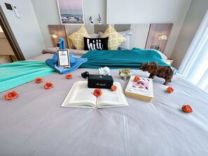 Cozy retreat with a reading nook, featuring a plush bed, book, and decorative elephant.
