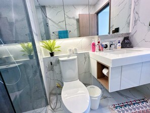 Enjoy a refreshing shower in the bathroom, featuring a sink, shower, and vanity.