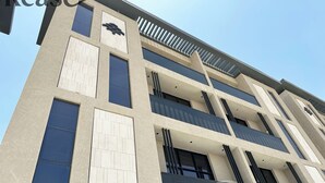 A multi-story building with a modern architectural design, featuring large windows and balconies. - Kease Yasmin 4-13 Ramz Terrace AG74 (Riyadh)