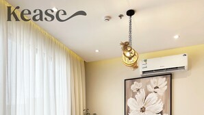A dining area with a wooden table, black chairs, a white rug, and a large floral painting on the wall. - Kease Yasmin 4-13 Ramz Terrace AG74 (Riyadh)