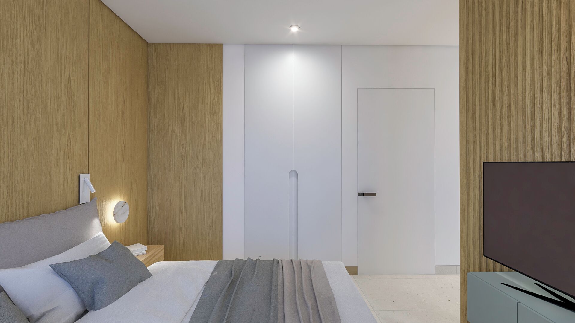 A modern bedroom with a bed, bedside table, and a TV.
