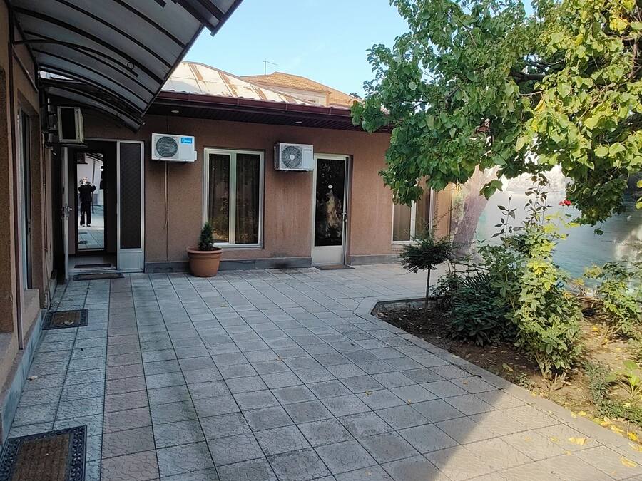 Un edificio con patio de baldosas, unidades de aire acondicionado y vistas a una masa de agua.