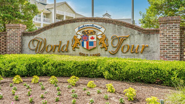 A sign for the International World Tour hotel with a brick wall and a landscaped garden in front. - World Tour Golf Resort Unit 103 - Golf view (Myrtle Beach)