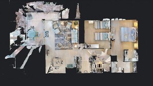 A hotel layout with multiple rooms, a dining area, and a reception desk.