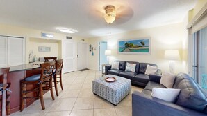A spacious living room with a dining area, a sofa set, and a coffee table. - Crescent Arms Vacation Rentals 205N Siesta Key Florida (Siesta Key)