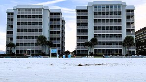 A modern hotel with multiple floors, balconies, and a beach view. - Crescent Arms Vacation Rentals 204N Siesta Key Florida DISCOUNTS! (Siesta Key)
