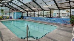 An indoor pool with a glass ceiling, a mural of marine life, and a blue wall with an 'Entrance' sign. - Octopus Garden: 1BR, King Bed, Indoor/Outdoor Pool (Carolina Beach)