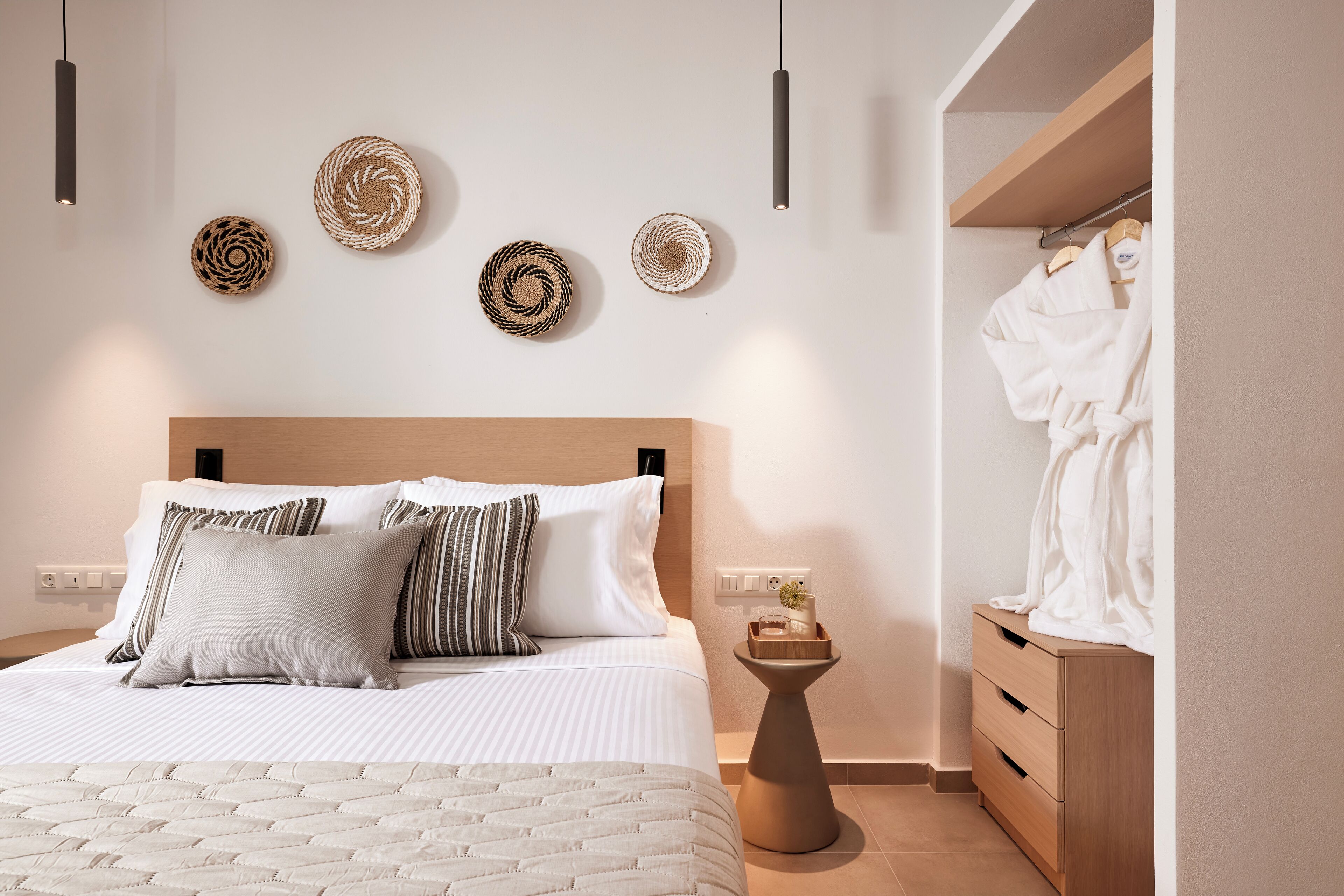 A bedroom with a bed, bedside table, and a wardrobe.