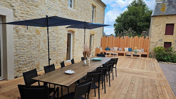 Outdoor dining - L'écho des vagues: Large stone house between land and sea. (Longues-sur-Mer)
