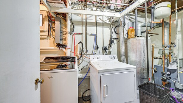 A laundry room with a washing machine, dryer, and various pipes and hoses. - Welcoming Glen Cove Home ~ 1 Mi to Public Beach! (Glen Cove)