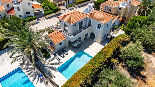 A modern residential complex with multiple two-story houses, a swimming pool, and lush landscaping. - Villa Sophia by Ezoria Villas (Paphos)
