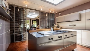 A modern kitchen with a central island, stainless steel appliances, and a skylight. - Villa Barbarella - Villa with private pool (San Gimignano)