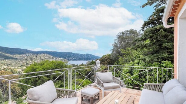 A balcony with wicker furniture and a view of a hilly landscape. - Villa Tanit - Swimming pool, sea view - 10 people (Le Lavandou)