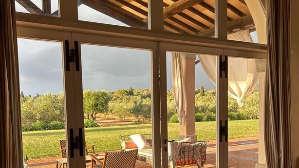 A room with large glass doors leading to an outdoor patio area. - Estate of Cosa,stunning mansion, swimming pool ,ac, wi-fi, sat  (orbetello)