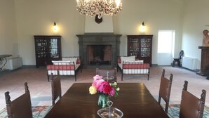 A formal dining room with a long table, chairs, a chandelier, and two fireplaces. - Estate of Cosa,stunning mansion, swimming pool ,ac, wi-fi, sat  (orbetello)