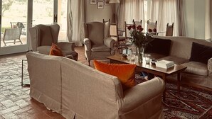 A spacious living room with a high ceiling, large windows, and a fireplace. - Estate of Cosa,stunning mansion, swimming pool ,ac, wi-fi, sat  (orbetello)