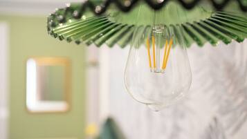 Una lámpara de cristal transparente con un adorno verde.