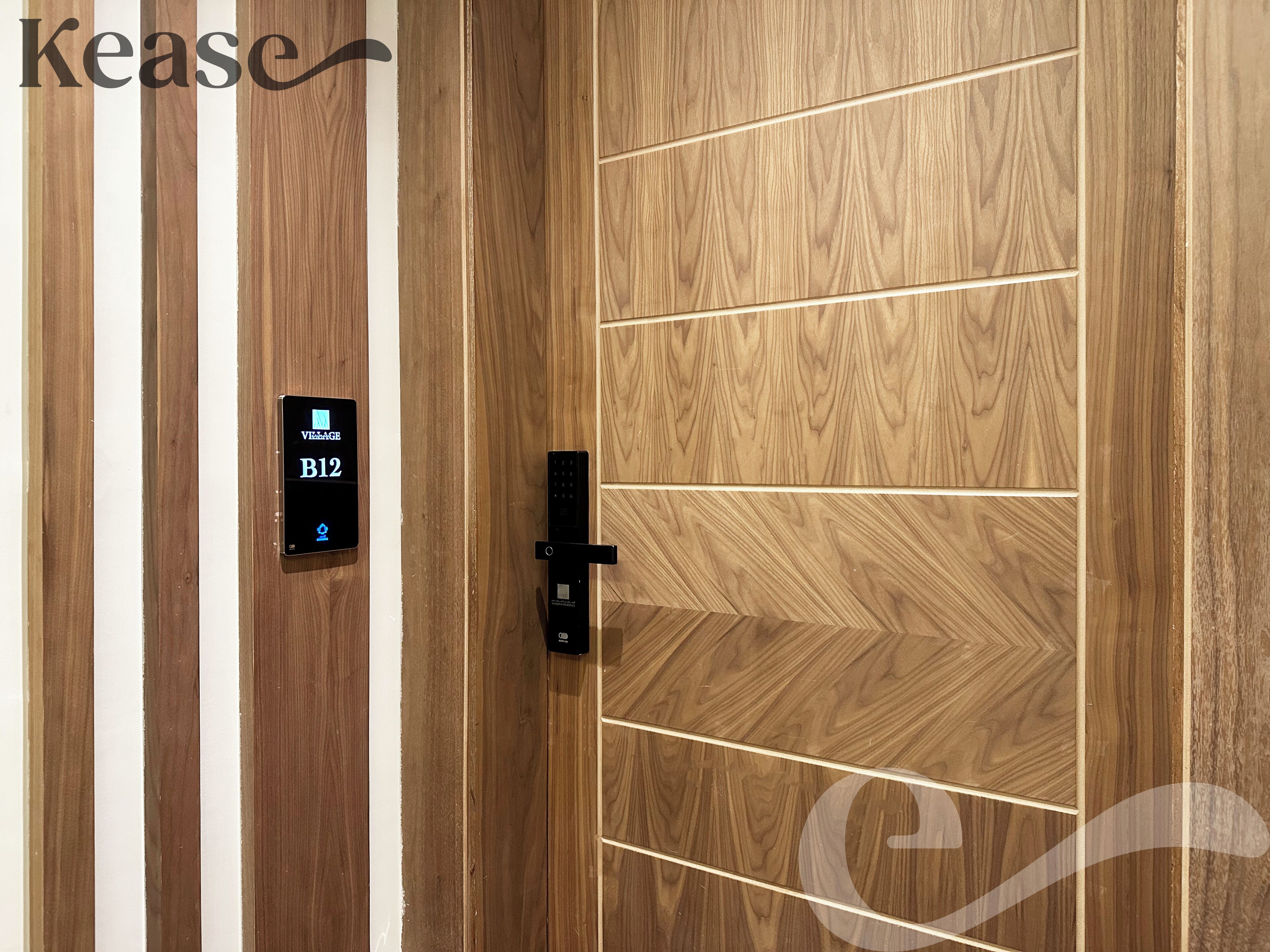 A wooden door with a digital lock and a keycard reader displaying 'VITEAGE B12'.