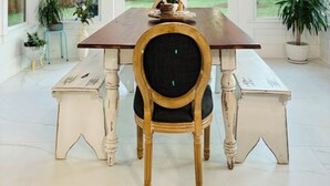 A dining area with a wooden table, a chandelier, and a chair. - Private 30A Retreat-Large Yard-Hot Tub-2 KING Suites-Fire Pit-Boat & RV parking. (Santa Rosa Beach)