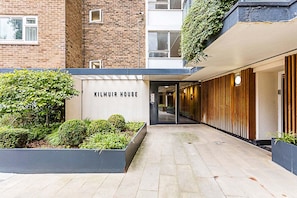 A modern building entrance with a sign reading "KILMUIR HOUSE".