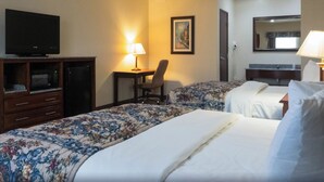 A hotel room with two beds, a desk, a television, and a chair. - Hiway Inn Express Of Coalgate (Coalgate)