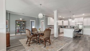 A modern kitchen with white cabinets, a central island, and pendant lighting. - Downtown`s BEST LOFT ON THE SQUARE  `THE FIDDLE`!!! (Smithville)