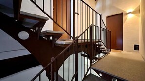 A staircase with a metal railing leading to a landing. - Don Bosco House (Chieri)