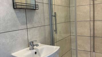 Shower, hair dryer, towels, shampoo