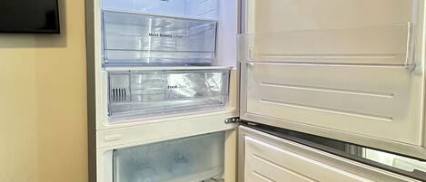 A white refrigerator with multiple compartments, including a 'Moist Balance Crisper' and a 'Fresh Zone.'