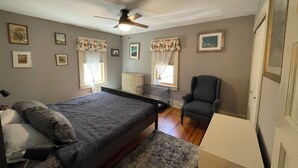 A bedroom with a bed, a chair, a radiator, and a ceiling fan. - Relax or be active! The choice is yours in this pet-friendly family home.  (Norfolk)